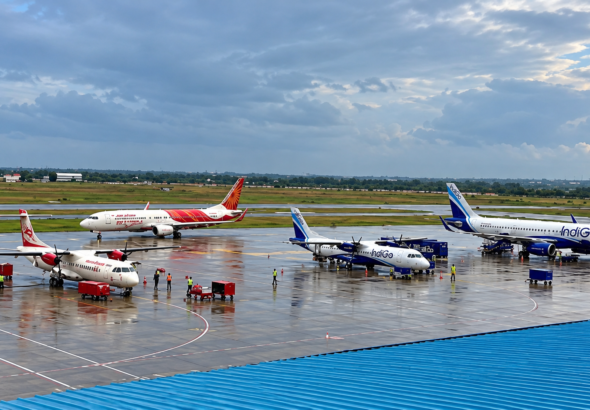 Rain-Soaked Airport Apron with Air India and IndiGo Jets