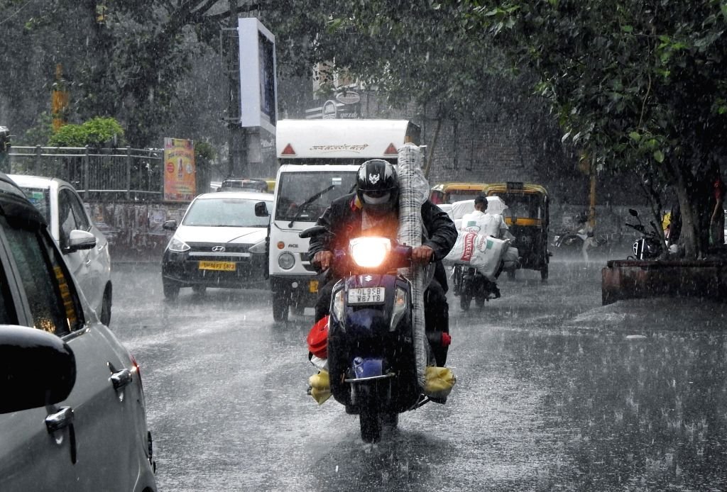 vehicles-ply-on-road-as-heavy-rainfall-lashes-in-1605572